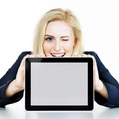 Woman winking over her tablet pc with copyspace