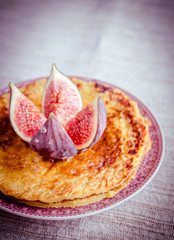 Pile of pumpkin crepes decorated with fresh fig