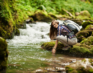 Young woman hiker by the river