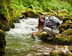 Young woman hiker by the river