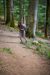 Fototapeta premium Woman with backpack hiking into the forest