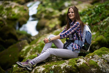 Woman hiker resting on rocks