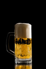 Full tankard of chilled beer with a frothy head