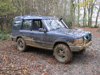 a very dirty muddy offroad car