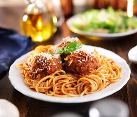 Poster italian food - spaghetti and meatballs at dinner table © Joshua Resnick