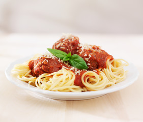 spaghetti and meatballs on empty table