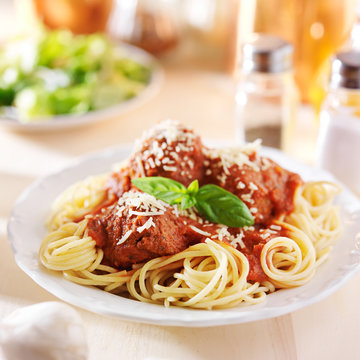 spaghetti and meatball dinner with salad