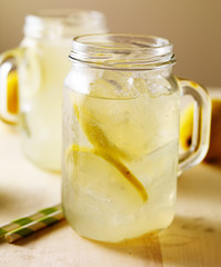 jar of fresh homemade lemonade on wood table