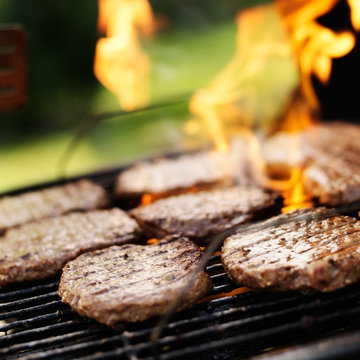 hamburgers grilling on charcoal grill
