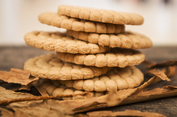 pile of delicious vanilla cookies surrounded by cinnamon sticks