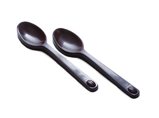 Spoons made ​​of dark chocolate, isolated on white