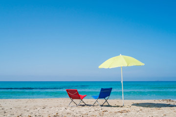 Beach umbrella and lounge chairs
