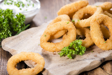 Onion Rings on wooden background