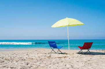 Beach umbrella and lounge chairs