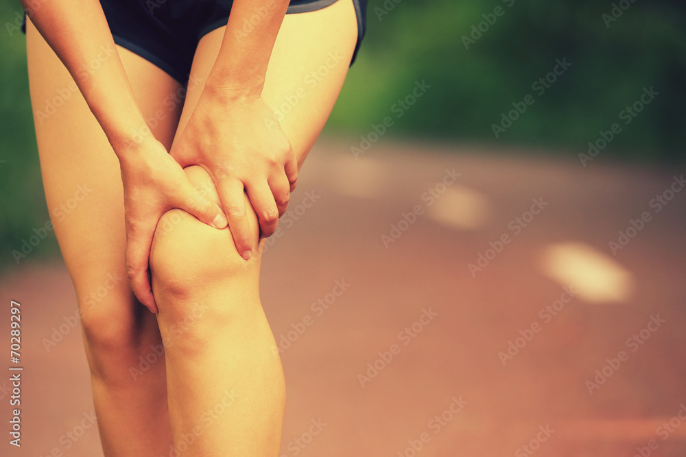 Poster woman runner hold her sports injured knee 