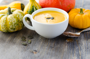 Pumpkin soup in a bowl copy space background