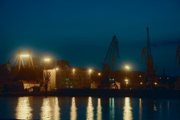 Fototapeta na wymiar Port Cranes At Night
