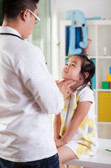 Pediatrician examining girl's lymph nodes