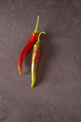 Red and green chilly pepper, on a stone