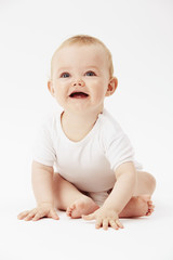 Young baby girl with mouth open, studio.