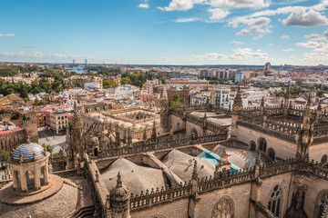 Fototapeta na wymiar Dome and roof of Seville Cathedral and view of city of Seville