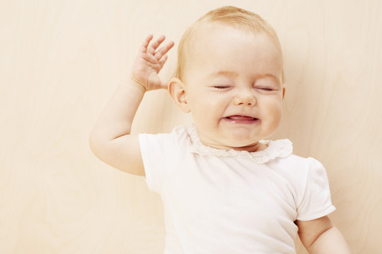 Baby girl with eyes closed, studio shot.