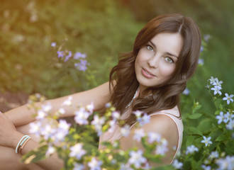 Fototapeta premium beautiful woman in park with flowers