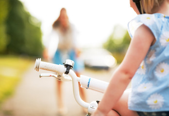 Closeup on baby girl sitting on bicycle  © Alliance
