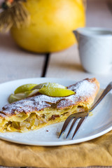 strudel dessert with pears on a white plate, .yellow napkin