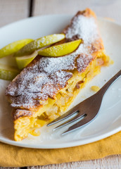 strudel dessert with pears on a white plate, .yellow, vertically