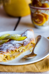 strudel dessert with pears on a white plate, .yellow napkin