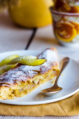 strudel dessert with pears on a white plate, .yellow napkin