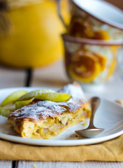 strudel dessert with pears on a white plate, .yellow napkin