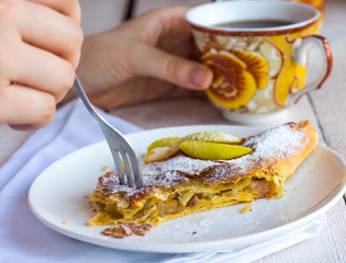 eat apple strudel on a white plate, hands, .fork
