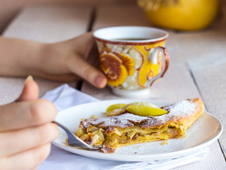eat apple strudel on a white plate, hands, .fork