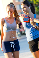 Group of young women doing stretching in the park.