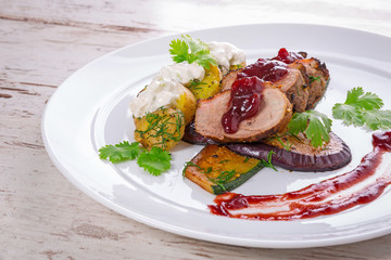 Roasted duck breast with cranberry sauce and vegetables