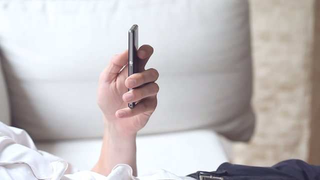 Man writting a message by smartphone movie