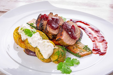 Roasted duck breast with cranberry sauce and vegetables