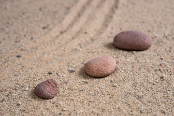 Fototapeta na wymiar zen garden sand waves and rock sculptures