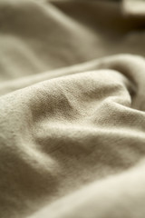 Close up of beige material on clothing.