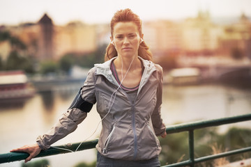 Fototapeta premium Portrait of fitness young woman in the city in the evening