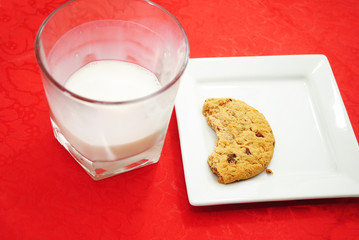 Half Eaten Cookie with an Almost Empty Glass of Milk