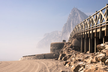 Beach with old bunker and The Rock of Gibraltar