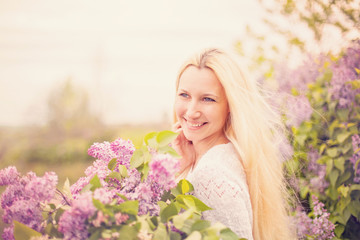 Young smiling woman with violet flowers