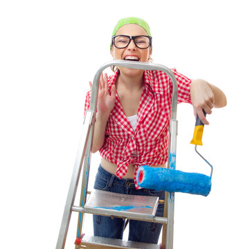 Expressive woman holding roller afore ladder