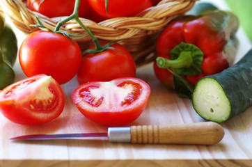 tomatoes and peppers on a wooden table