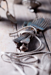 Vintage spoon and forks roped on a wooden table