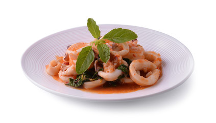 squids fried with chilli pepper and sweet basil on white backgro