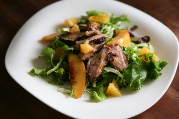 Salad with roasted duck breast and orange